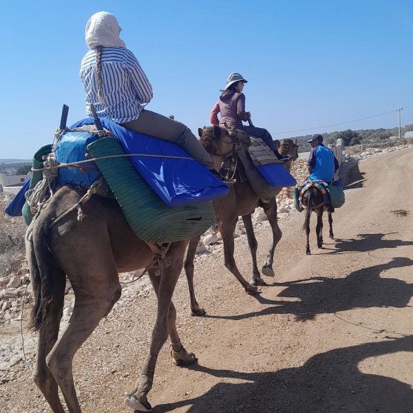 two women riding camels with Momo in Sidi Kaouki