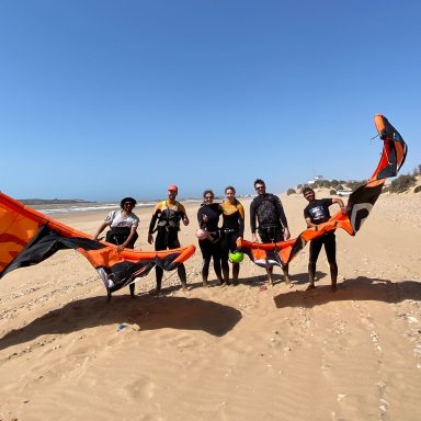 four people after having a kite surf lesson on the beach of Sidi Kaouki with Momo and his team