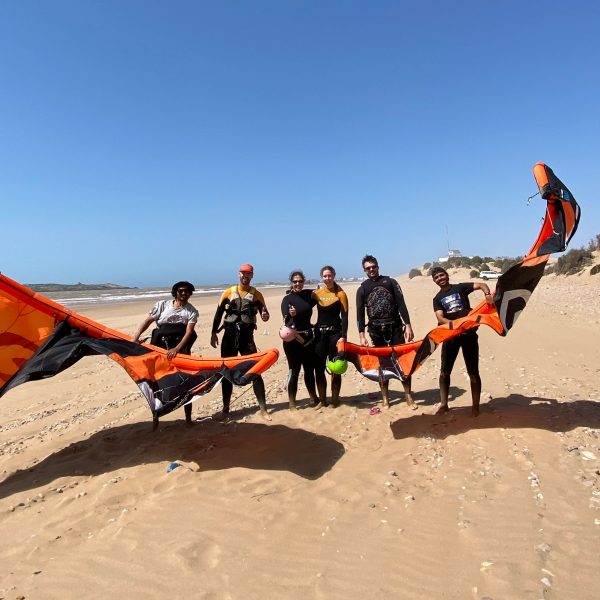 four people after having a kite surf lesson on the beach of Sidi Kaouki with Momo and his team