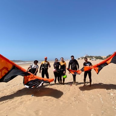 four people after having a kite surf lesson on the beach of Sidi Kaouki with Momo and his team